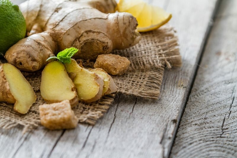 Ginger lemon mint honey on rustic wood background